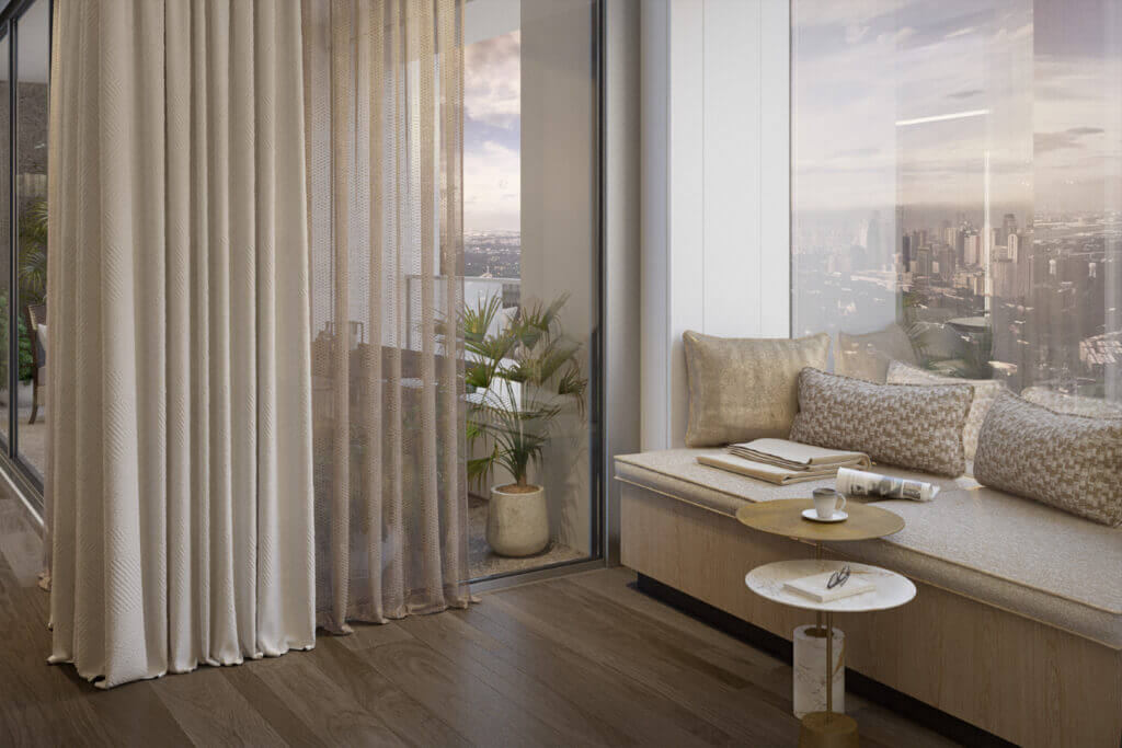 Luxury living area with large bay window, neutral-toned sofa, and decorative indoor plant.