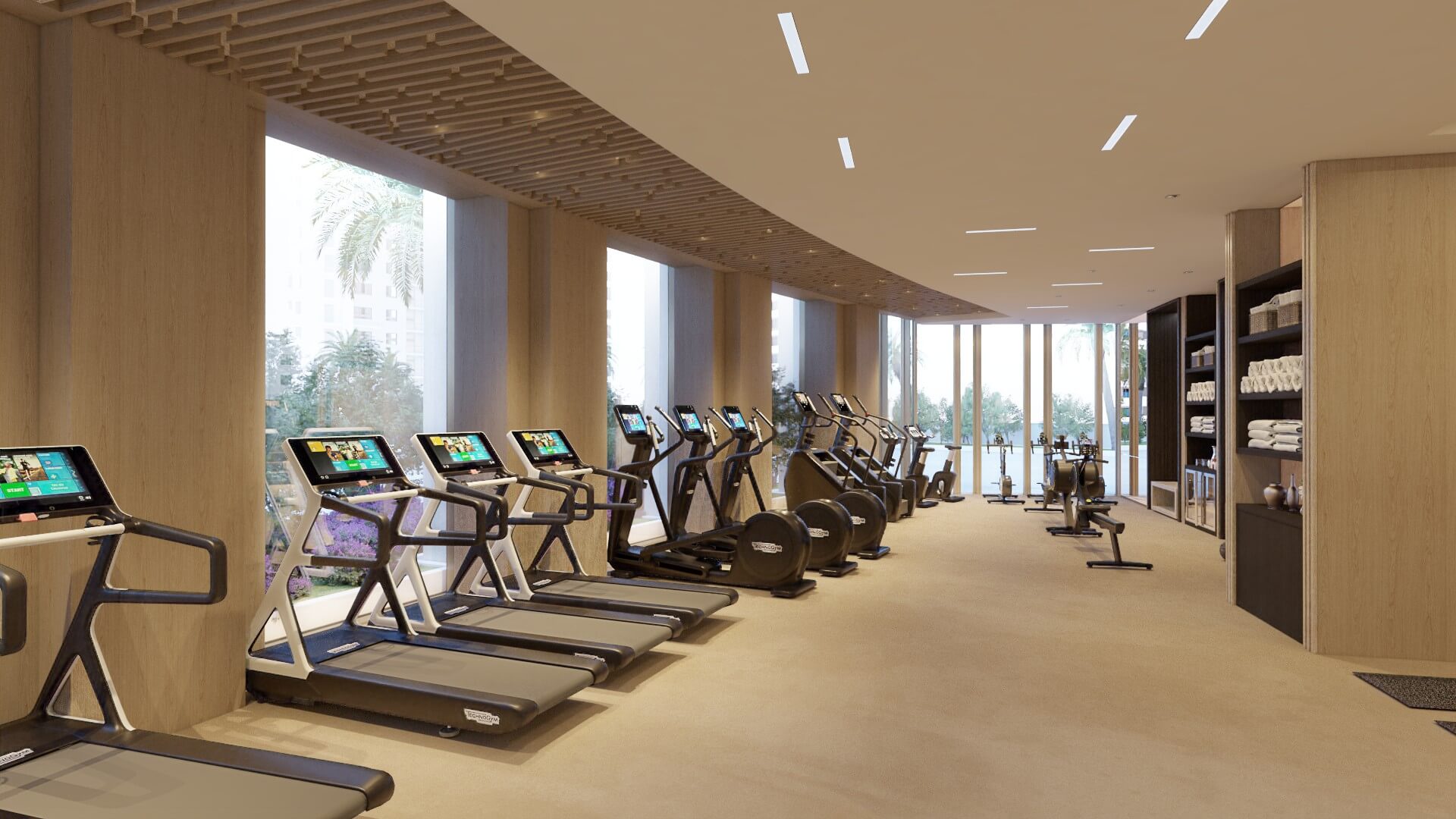 Cardio zone with line of professional treadmills facing large windows in bright, contemporary gym setting.