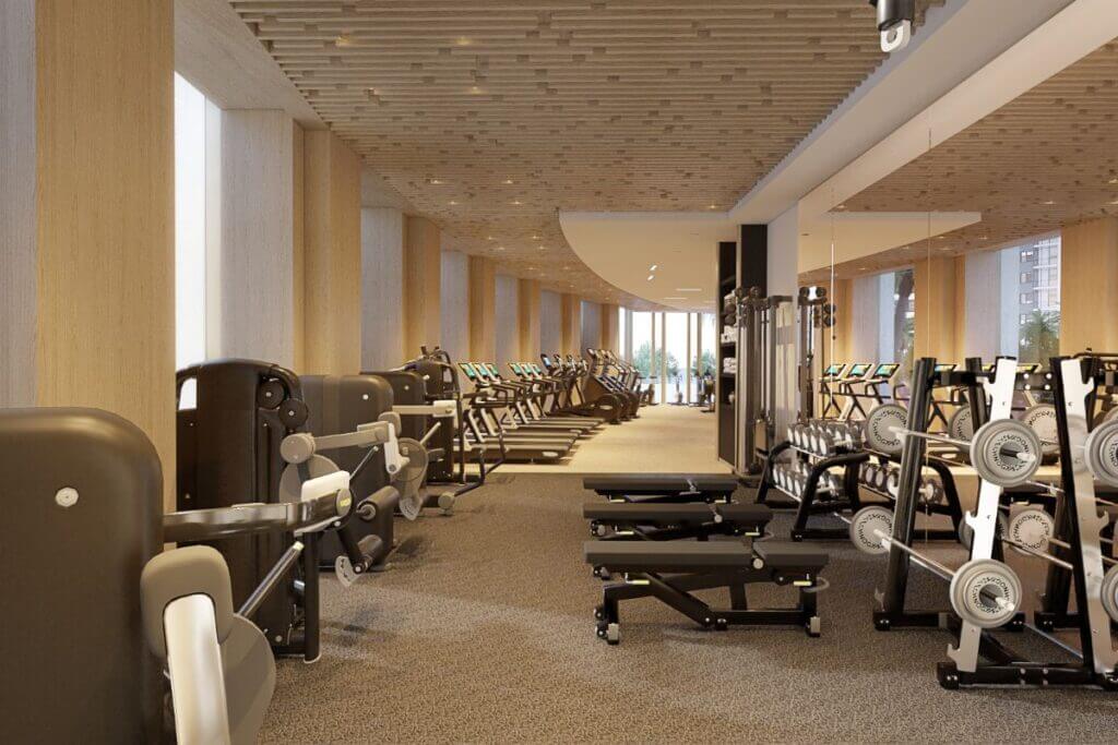 Long row of professional gym equipment and strength training machines in a bright, contemporary fitness room