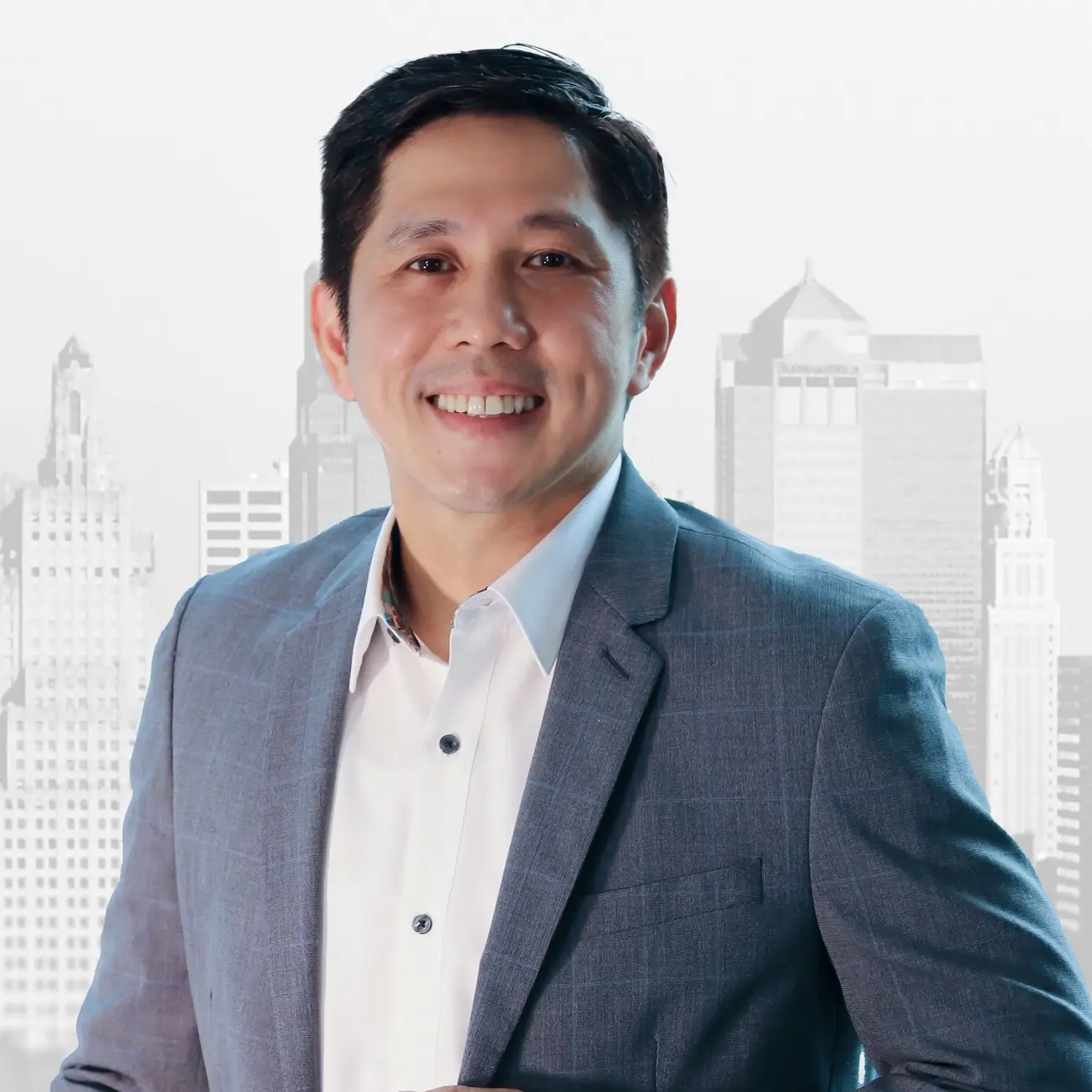 Smiling man in a grey plaid suit jacket and white shirt, against a faded cityscape background.